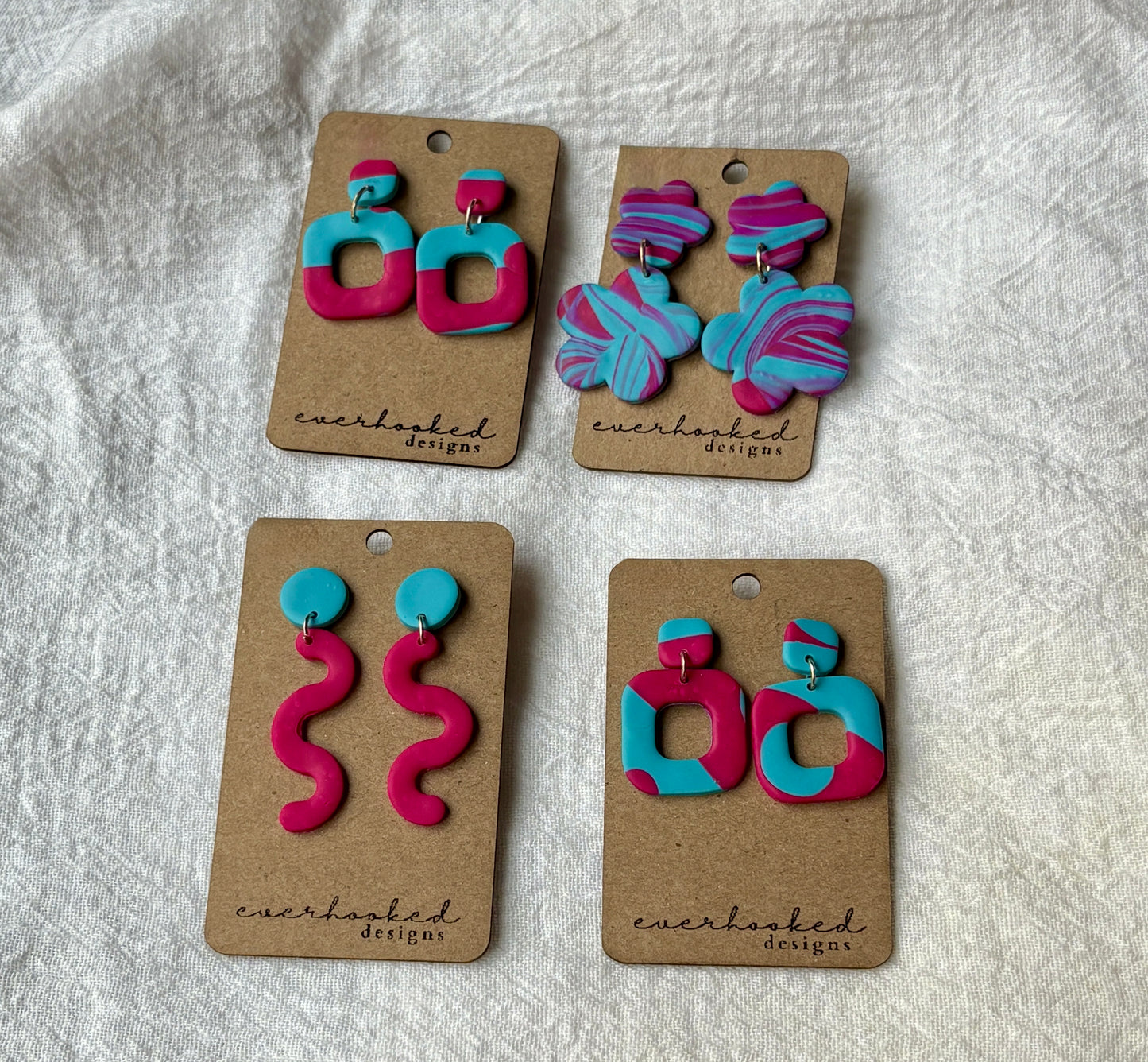 One-of-a-kind polymer clay earrings with a colorful swirl pattern in shades of pink, blue, and purple. Artistic, vibrant, and lightweight for comfortable wear.