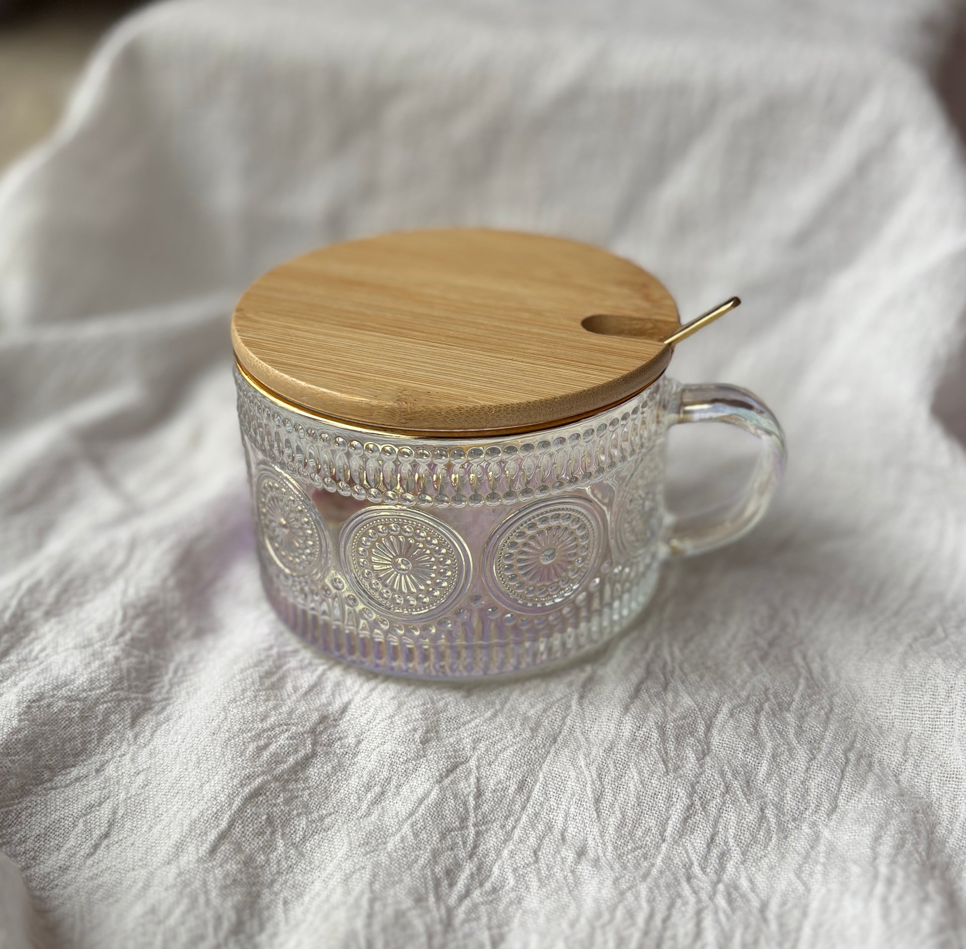 Circular pattern clear embossed glass mug with bamboo lid and gold spoon
