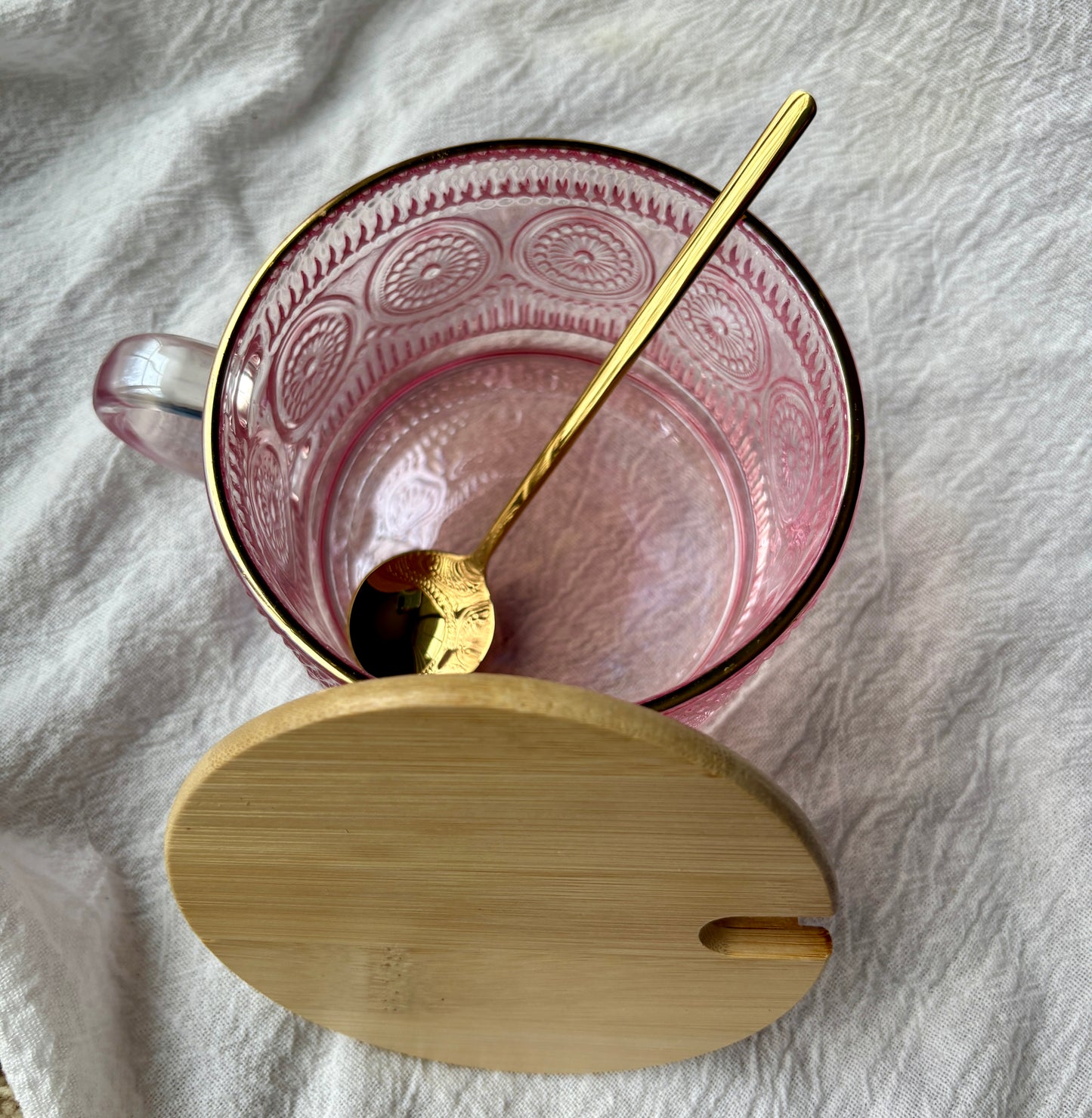 Pink embossed glass mug with bamboo lid and gold spoon