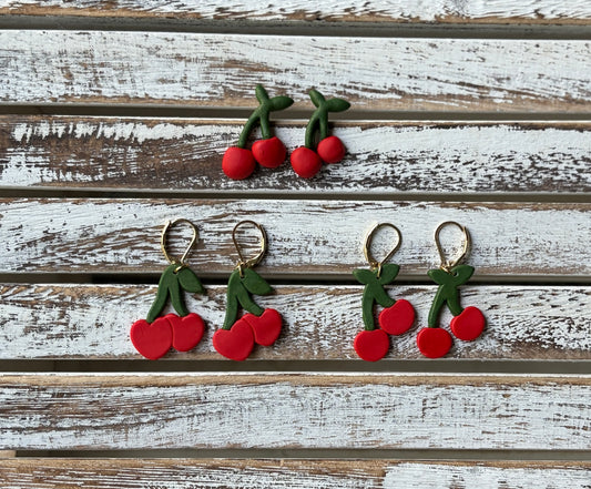 Three variations of adorable cherry earrings, stud earrings, regular cherry dangles, and heart cherry dangles