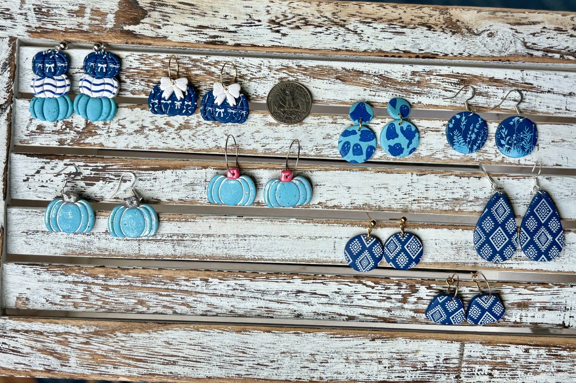 Blue fall polymer clay earrings including pumpkins, florals, ghosts, and geometric patterns