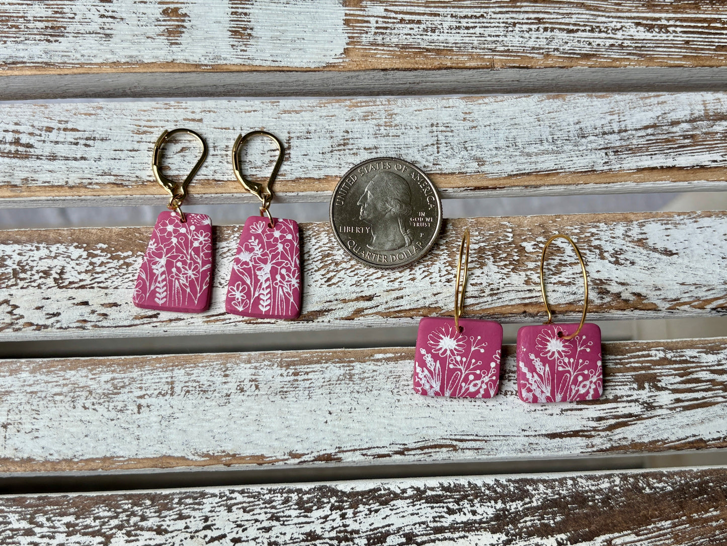 Pink dangles with white wildflowers and gold dangles with coin to compare