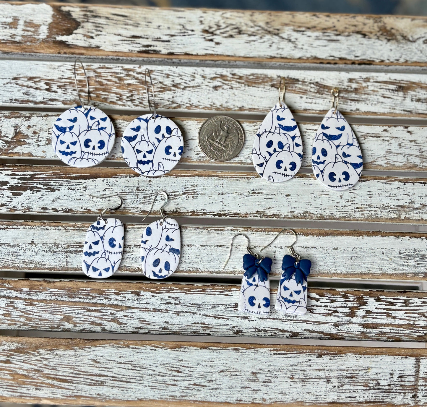 White and blue polymer clay jack-o-lantern earrings in multiple shapes and sizes